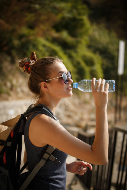 istock Female hiker drinking water 1145121546