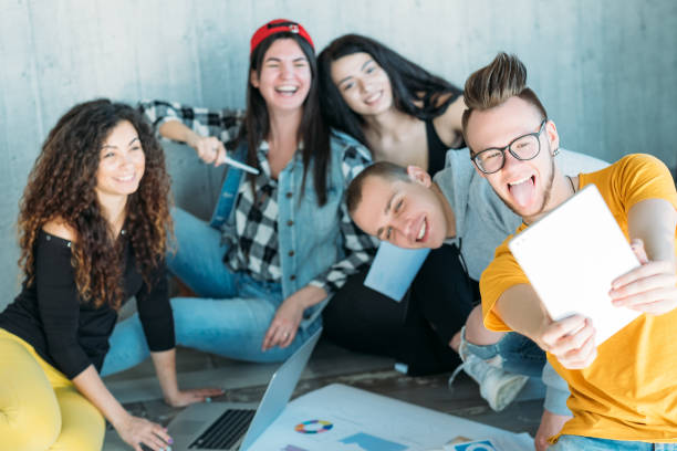 istock millennials corporate atmosphere team selfie 1145121715