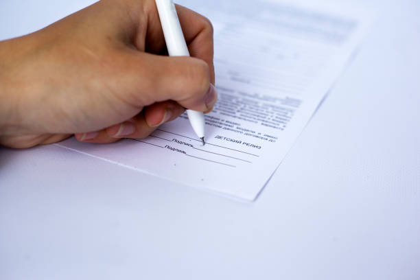 istock hand signs a document blank,contract.signature model release 1145122351