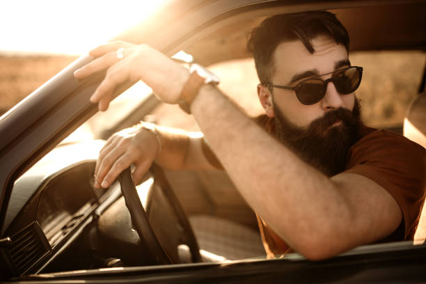 istock Hipster men traveling in his old timer car 1145129575