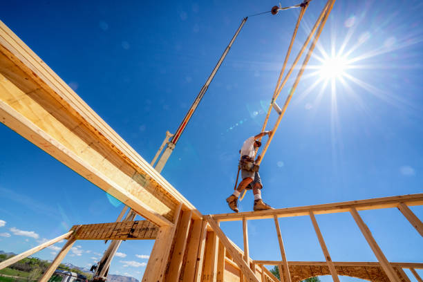 istock Rugged Carpenter on a Framing Crew Setting Trusses on a New Home 1145134159