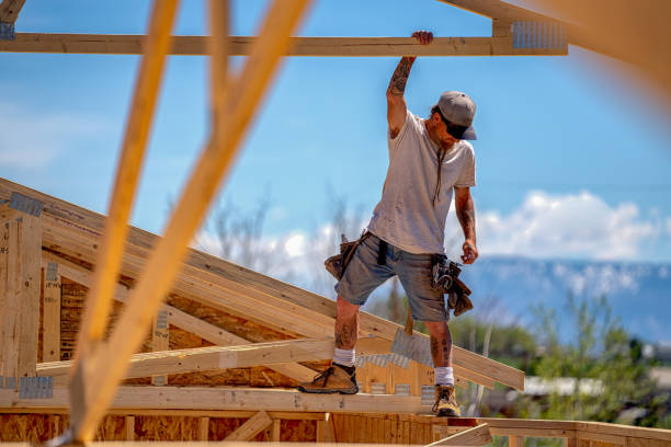istock Rugged Carpenter on a Framing Crew Setting Trusses on a New Home 1145134190
