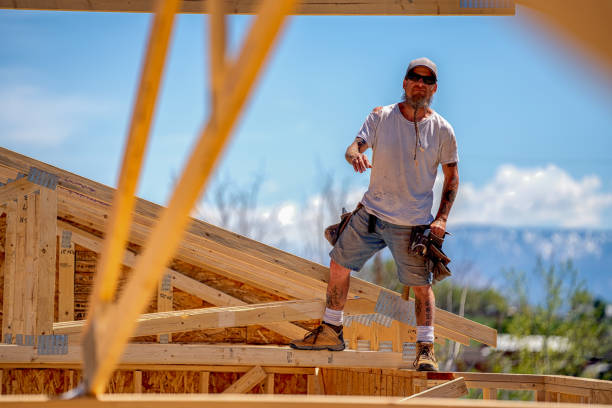 istock Rugged Carpenter on a Framing Crew Setting Trusses on a New Home 1145134284
