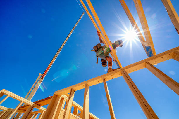 istock Rugged Carpenter on a Framing Crew Setting Trusses on a New Home 1145134338