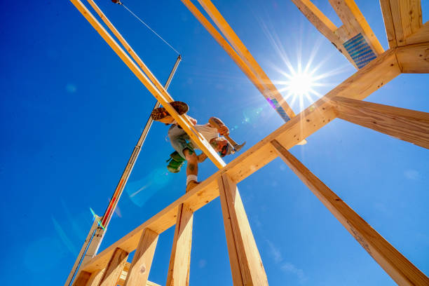 istock Rugged Carpenter on a Framing Crew Setting Trusses on a New Home 1145134393