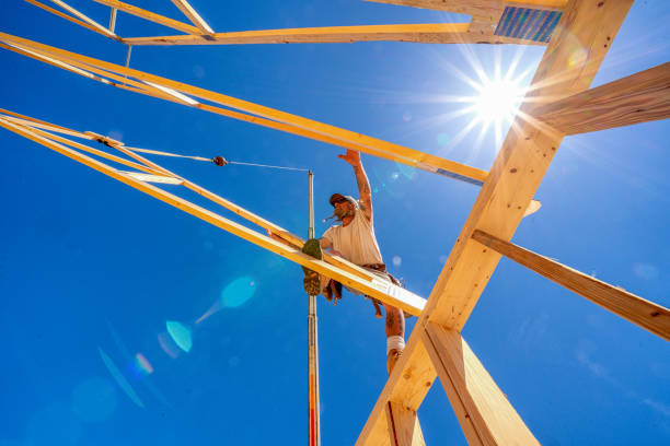 istock Rugged Carpenter on a Framing Crew Setting Trusses on a New Home 1145134414
