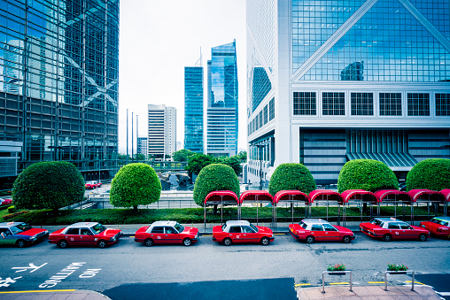 row of red taxies parked at roadside,Hong Kong,China.