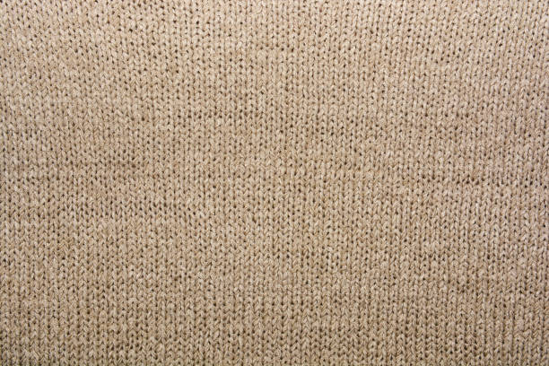 istock Abstract beige knitted fabric for background.Knitted texture. 1145140493