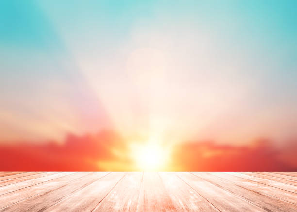 istock The blur pastels gradient sunset background with wood floor foreground on soft sunshine sunrise peaceful morning beach outdoor. heavenly mind view at a resort deck touching sunshine, sky summer clouds 1145143107