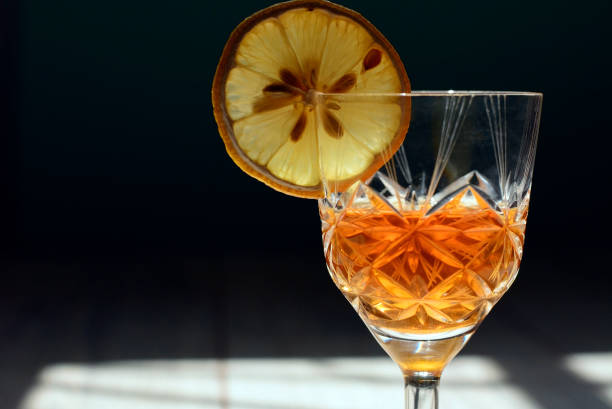 istock crystal wine glass with drink and lemon 1145145925