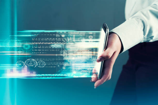 istock Hand holds a smartphone and transfering data.Futuristic technology concept. 1145145927