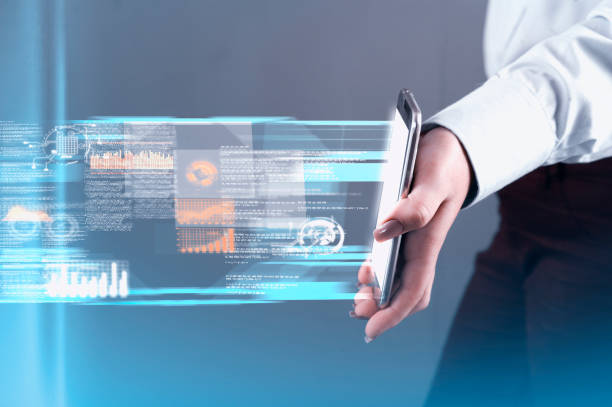istock Hand holds a smartphone and transfering data.Futuristic technology concept. 1145145944
