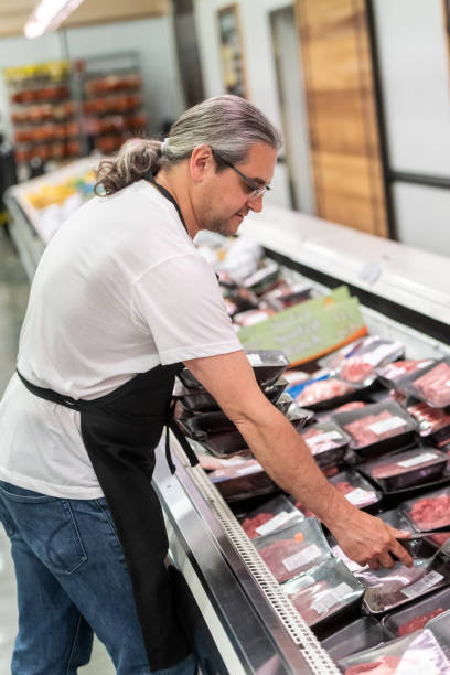istock Mature man working at a supermarket meat section 1145147746