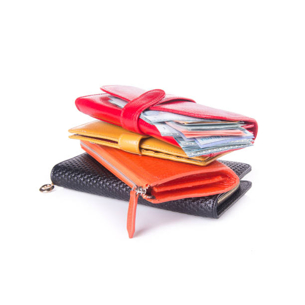purse with dollars and credit cards on background