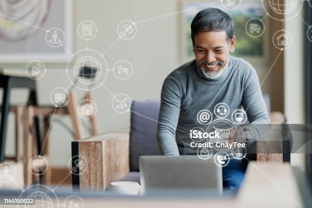 Asian Or Hispanic Man Using Laptop And Credit Card Payment Shopping Online With Icon Customer Network Connection On Screen And Connecting With Omni Channel System Older Man Satisfied With Crm System Stock Photo - Download Image Now
