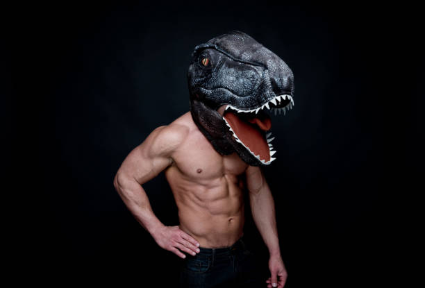 istock Sexy muscular man wearing a dinosaur mask 1145150915