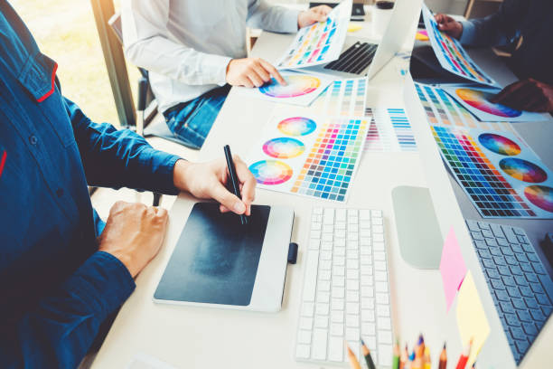 istock Two Graphic designer drawing on graphics tablet and color palette guide at workplace 1145151240