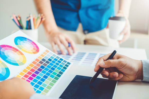 istock Two Graphic designer drawing on graphics tablet and color palette guide at workplace 1145151308
