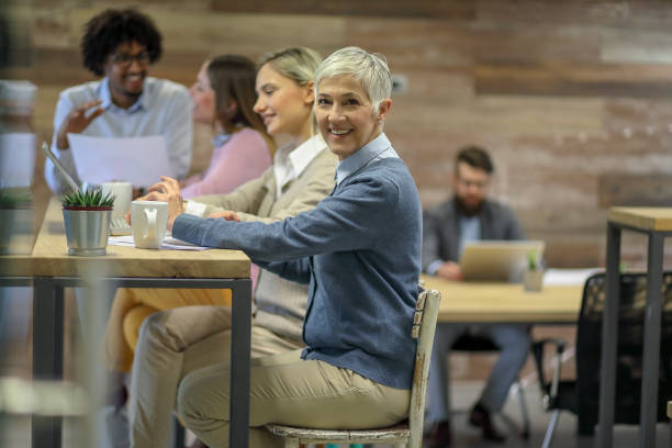 istock Group of multi generation business colleagues  in open hub office 1145152513