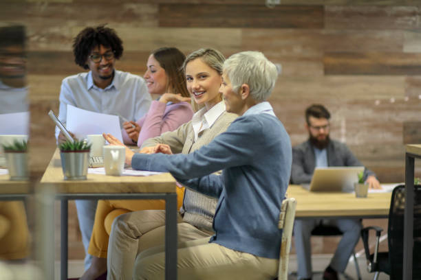 istock Group of multi generation business colleagues  in open hub office 1145152523