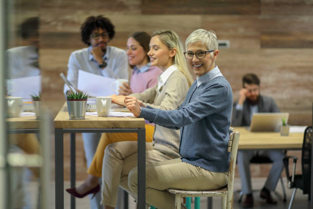 istock Group of multi generation business colleagues  in open hub office 1145152667