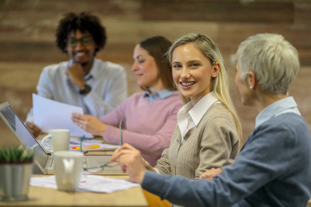 istock Group of multi generation business colleagues  in open hub office 1145153226