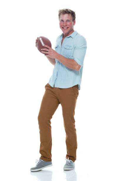istock Casually dressed man holding a football 1145153302