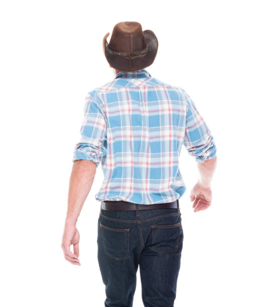 istock Handsome cowboy is walking, rear view 1145153326