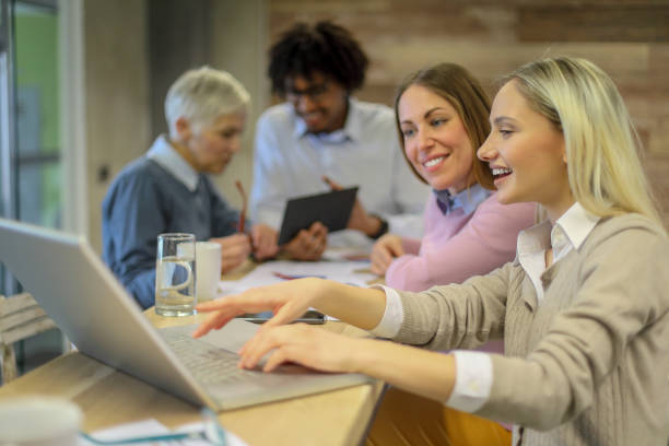 istock Group of multi generation business colleagues  in open hub office 1145153631