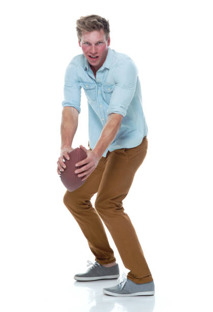 istock Casually dressed man holding a football 1145153952