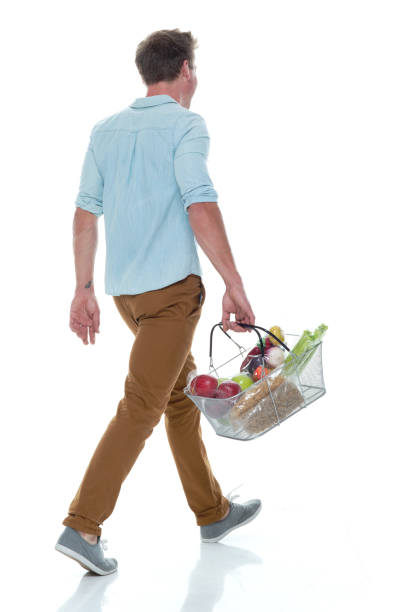 istock Handsome male holding shopping basket with vegetables 1145154520