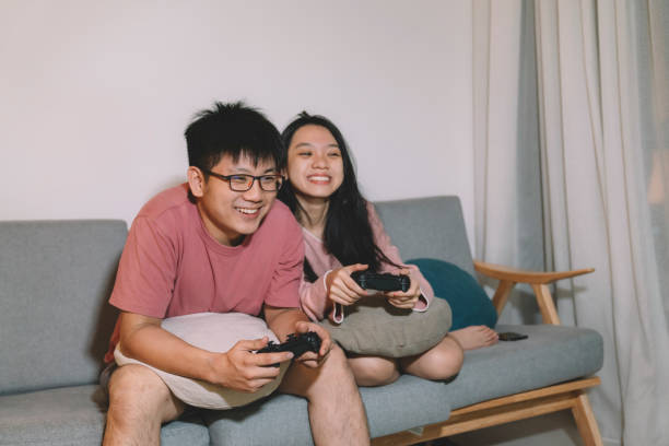 istock Asian Chinese Couple playing games at Home 1145155276