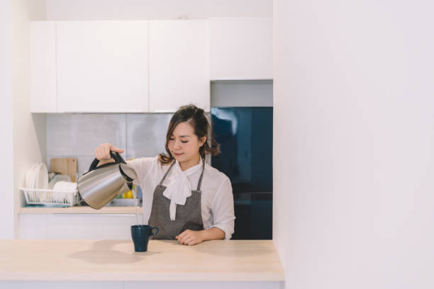 istock asian chinese female pouring coffee 1145155282