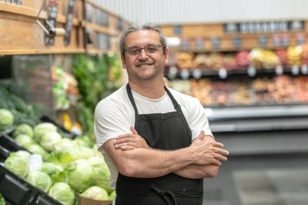 istock Mature man working at a supermarket vegetables and fruit section 1145157976