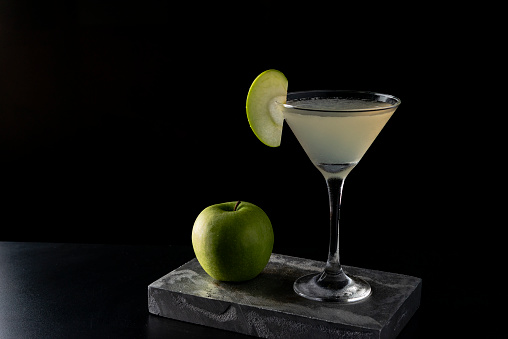 Apple Martini cocktail is on the bar. Space for text. Photo for the menu.