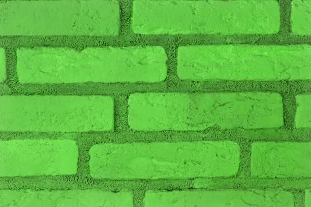 istock design shabby green brick wall texture for use as background. 1145161785