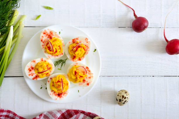 istock Deviled eggs. Delicious appetizer. Boiled eggs stuffed with yolk, mustard, mayonnaise, paprika. Classic recipe. The top view 1145164048