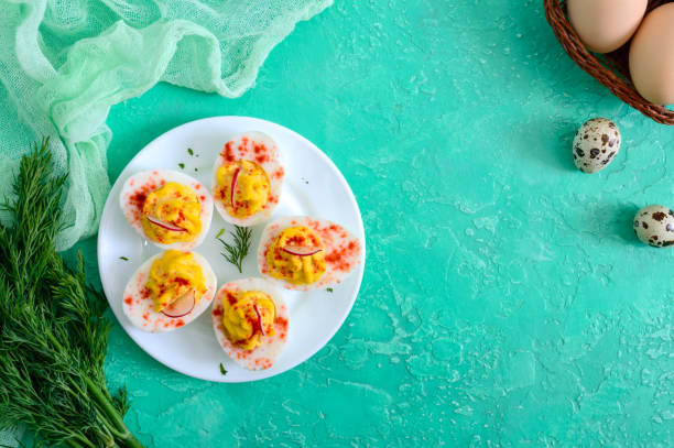 istock Deviled eggs. Delicious appetizer. Boiled eggs stuffed with yolk, mustard, mayonnaise, paprika. Classic recipe. The top view 1145164052