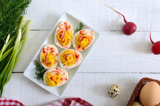 istock Deviled eggs. Delicious appetizer. Boiled eggs stuffed with yolk, mustard, mayonnaise, paprika. Classic recipe. The top view 1145164053