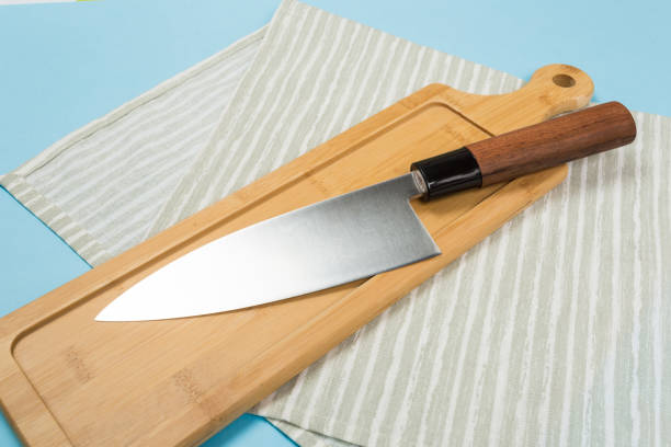 istock Big kitchen knife lying on an cutting board 1145166371