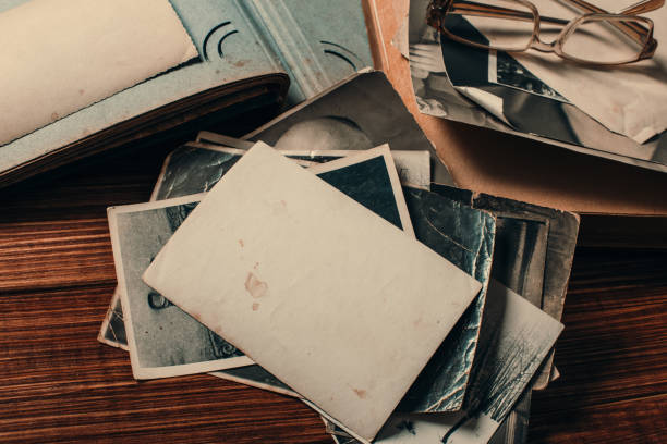 istock Stack old photos on table. Mock-up blank paper. Postcard rumpled and dirty vintage. Retro card 1145166499
