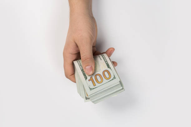 istock woman hand with dollars isolated on a white background 1145167054