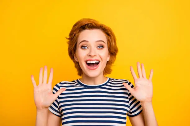 Photo of Close up photo beautiful amazing she her lady hands arms raised high-five sign symbol goodbye hi hey say wearing casual striped white blue t-shirt outfit clothes isolated yellow bright background