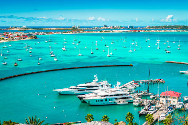 Luxury yachts and boats in the marina of Marigot, St Martin, Caribbean. Bright and colorful harbor view with yachts and boats in the marina of Marigot in Saint Martin, French side of the Caribbean Island. saint martin caribbean stock pictures, royalty-free photos & images