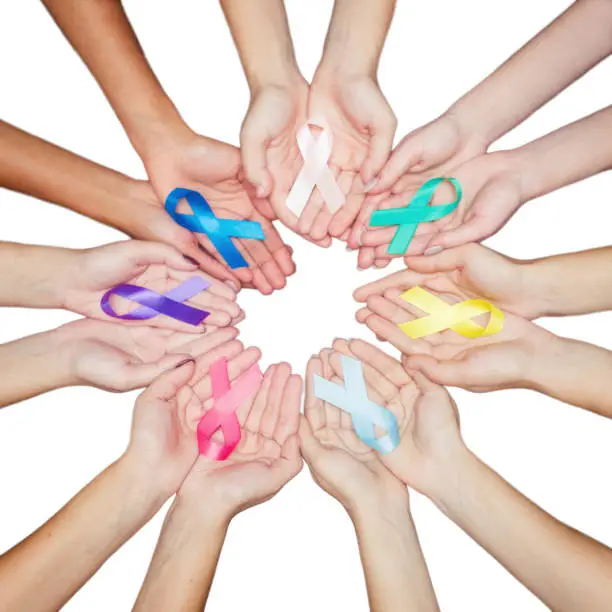 colorful ribbons, cancer awareness, World cancer day background. many ribbons on hands isolated on white.