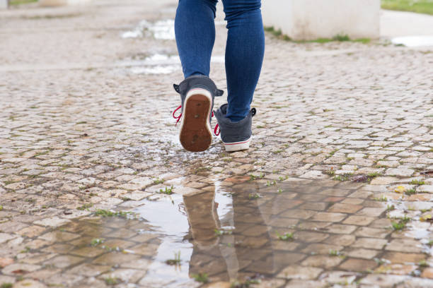 istock Close-up of unrecognizable woman walking on stone pathway 1145169234