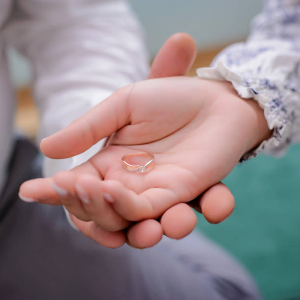 istock Engagement ring in the hands of lovers 1145172307