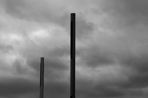Two metal poles (scaffolding) pointing to the sky.