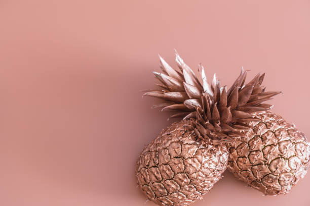 istock Gold colored pineapple on a colored background. Tropical flat lay. Food concept. 1145173250