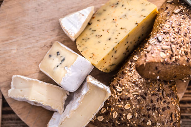 istock Cheese different cutting on a wooden plate 1145173345
